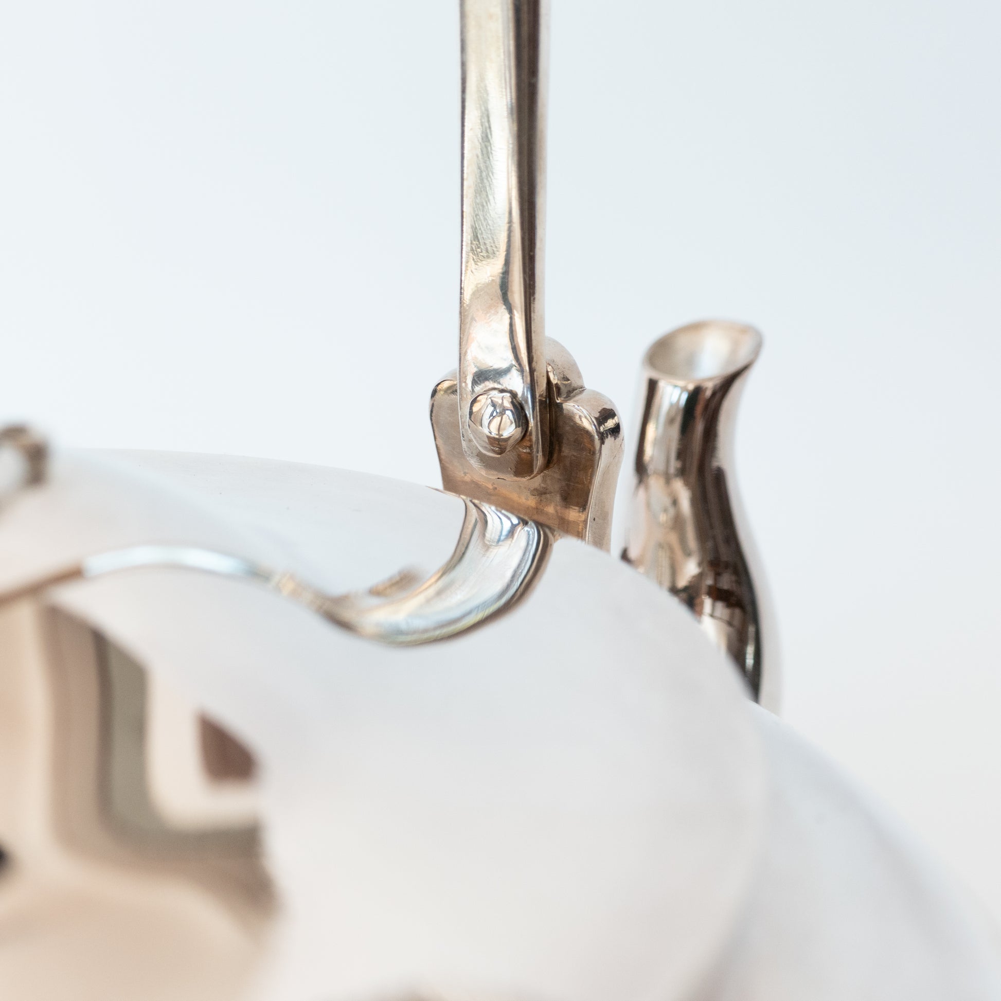 close up of silver kettle/teapot handle and spout